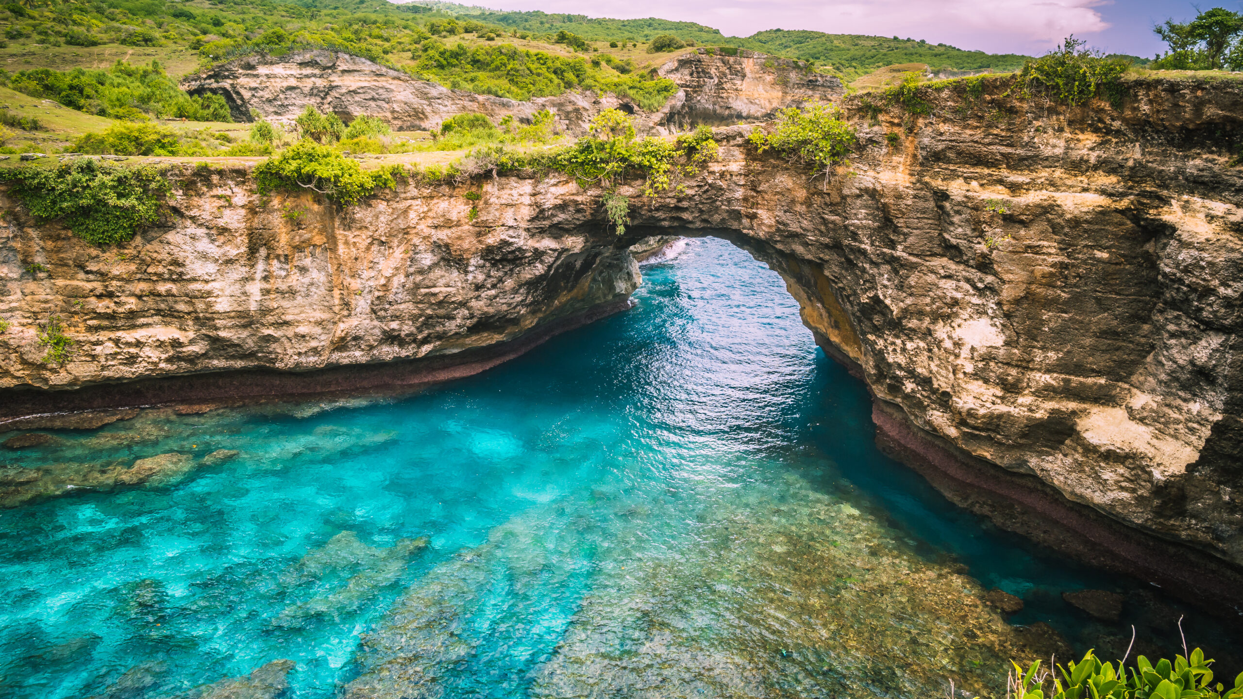 Rock coastline. Stone arch over the sea. Broken beach, Nusa Penida ,Indonesia.